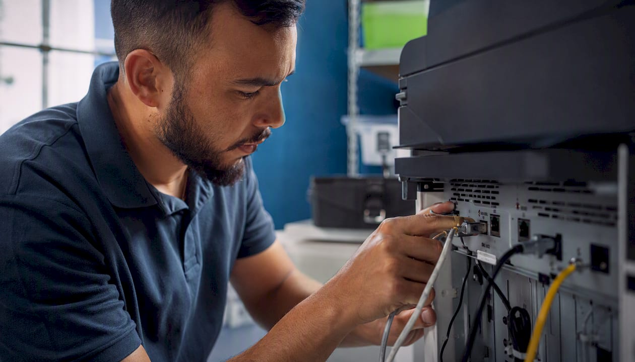 Technician securing printer network ports
