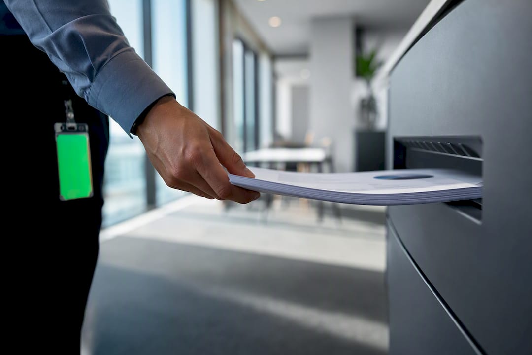 Employee collecting securely released office pages