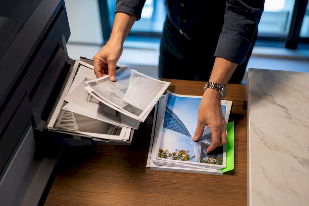 Office manager sorting monochrome and colour pages
